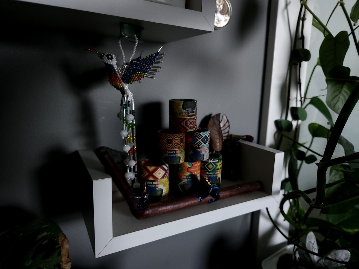 Studio shelf at Michael Jaece's Orem, Utah massage practice with beaded hummingbird, candles, and small ceremonial objects.